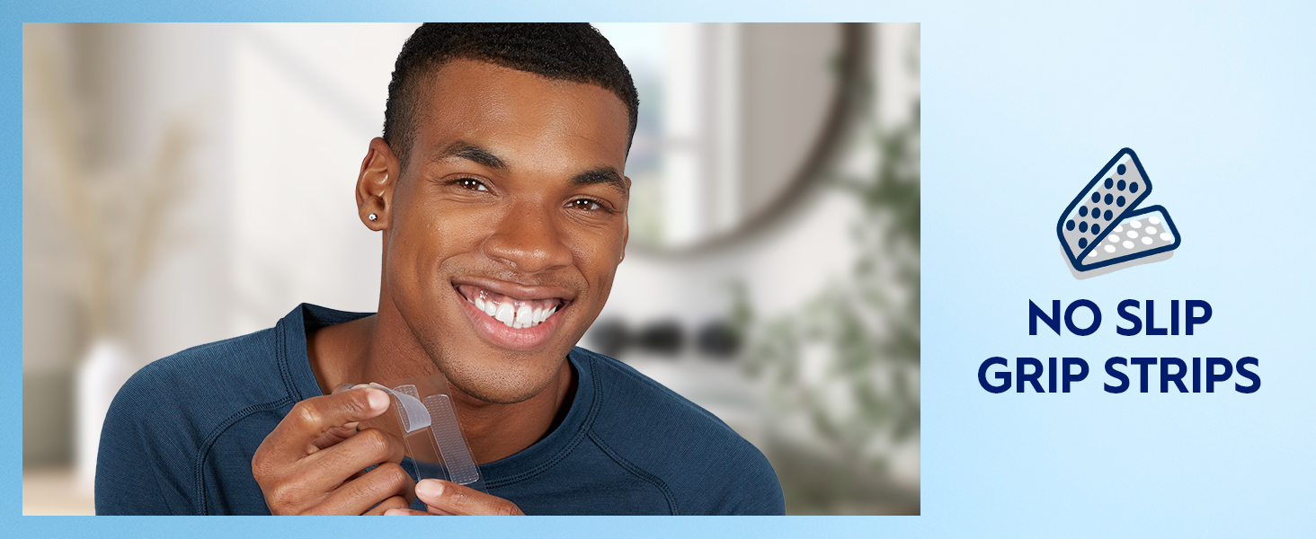 A man smiles bright while holding a Crest 3DWhitestrips strip. Claim reads: No slip grip strips.