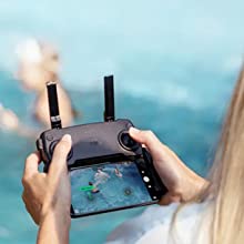 Controller with cell phone showing people in a pool