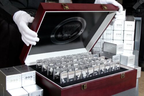 Wooden Display Chest with All 50-States Silver Bars, One of Each State, .999 Fine Silver, Left View with White-Gloved Hands Holding Chest Lid