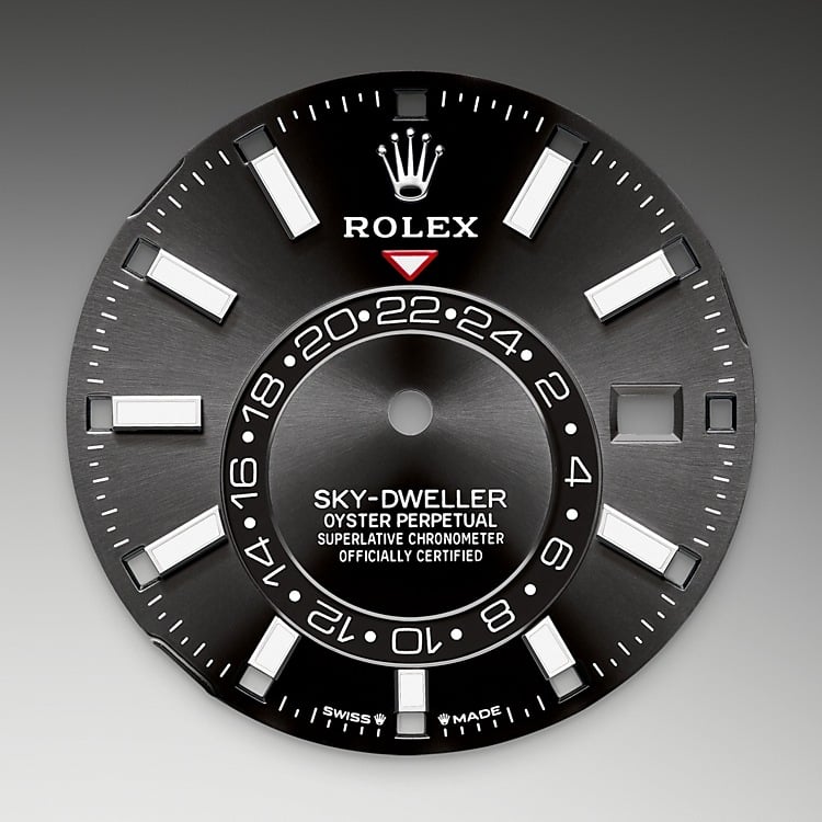 <p>A fixed inverted red triangle on the dial points to the chosen reference time – the time at home or at the traveller’s usual workplace – on the off-centre 24-hour disc. At a glance, this 24-hour display clearly distinguishes daytime hours from night-time hours in the other time zone. The dials now feature rectangular index hour markers and longer hands, as well as a Chromalight display with long-lasting luminescence, which enhances legibility. </p>
<p>A deep red rectangle in one of the 12 windows around the dial indicates the current month, a striking characteristic of the Saros annual calendar. This ingenious mechanism simplifies life for the wearer of the watch, who no longer needs to think about adjusting the date at the end of a 30-day month. The annual calendar displays the correct date through the year. Only one adjustment is needed – on 1 March (February having only 28 or 29 days). The date is connected to local time and automatically changes according to the traveller’s local time zone.</p>