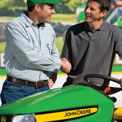 John Deere dealer shaking customer hand