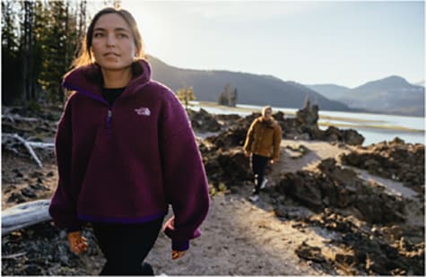 man and woman walking on a mountain