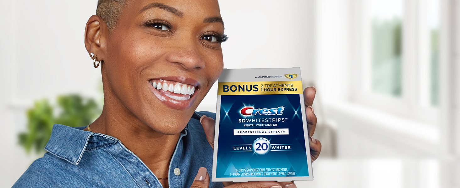 Woman holds Crest 3Whitestrips Professional Effects box while smiling bright.