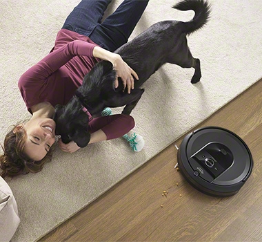 iRobot Roomba i7 is cleaning next to a carpet