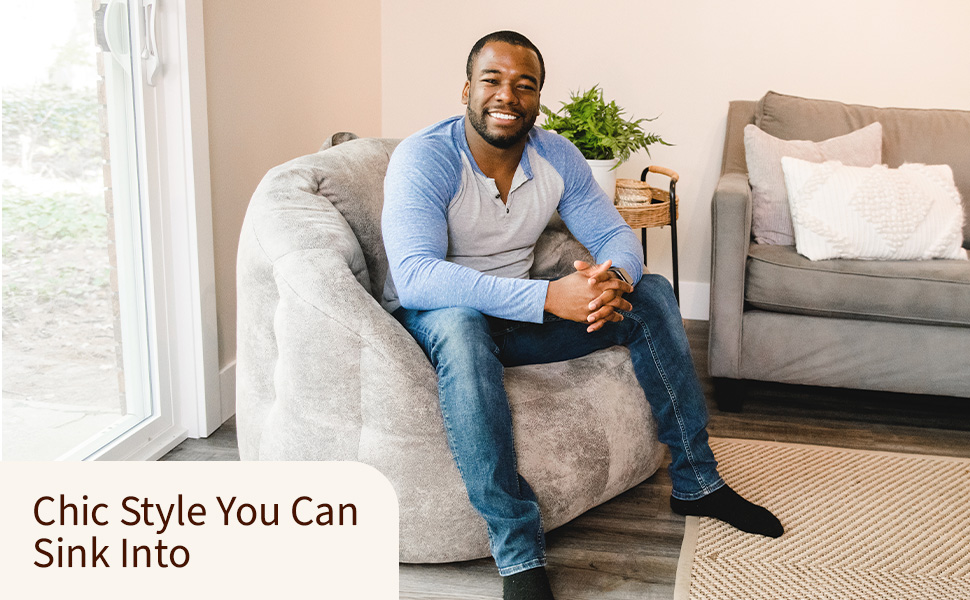 Man sitting on bean bag in a living room with sofa. Text reads: "Chic Style You Can Sink Into."